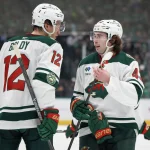 Apr 18, 2026; Dallas, Texas, USA; Minnesota Wild left wing Matt Boldy (12) talks to defenseman Quinn Hughes (43) during a stoppage of play against the Dallas Stars in the first period in game one of the first round of the 2026 Stanley Cup Playoffs at American Airlines Center.
