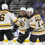 Nov 12, 2024; St. Louis, Missouri, USA; Boston Bruins right wing David Pastrnak (88) celebrates with defenseman Charlie McAvoy (73) and defenseman Mason Lohrei (6) after scoring the game winning goal against the St. Louis Blues during the third period at Enterprise Center.