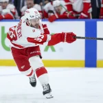 Mar 12, 2026; Tampa, Florida, USA; Detroit Red Wings right wing Alex DeBrincat (93) shoots the puck against the Tampa Bay Lightning in the second period at Benchmark International Arena.