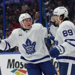 Nov 30, 2024; Tampa, Florida, USA;Toronto Maple Leafs left wing Nicholas Robertson (89) its congratulated by center Fraser Minten (39) after he scored a goal against the Tampa Bay Lightning during the second period at Amalie Arena.