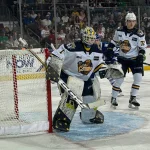 Erie Otters defenseman Alexis Daviault flanks goaltender Noah Erliden, who made his home debut for the team during its Sept. 28, 2024, Ontario Hockey League game vs. the Brampton Steelheads.