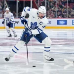 Mar 10, 2026; Montreal, Quebec, CAN; Toronto Maple Leafs forward Auston Matthews (34) plays the puck during the third period against the Montreal Canadiens at the Bell Centre.