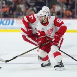 Apr 2, 2026; Philadelphia, Pennsylvania, USA; Detroit Red Wings right wing Alex Debrincat (93) controls the puck against the Philadelphia Flyers in the first period at Xfinity Mobile Arena.