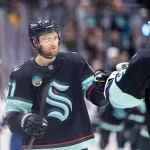 Jan 29, 2026; Seattle, Washington, USA; Seattle Kraken forward Shane Wright (51) celebrates a goal wiht Seattle Kraken goalie Joey Daccord (35) during the third period against the Toronto Maple Leafs at Climate Pledge Arena.