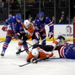 Dec 20, 2025; New York, New York, USA; Philadelphia Flyers centers Sean Couturier (14) and Denver Barkey (52) fight for the puck against New York Rangers defenseman Carson Soucy (24) and center Mika Zibanejad (93) and goaltender Igor Shesterkin (31) during the first period at Madison Square Garden.