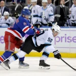 Jan 5, 2026; New York, New York, USA; New York Rangers left wing Alexis Lafreniere (13) hits Utah Mammoth defenseman Sean Durzi (50) during the second period at Madison Square Garden.