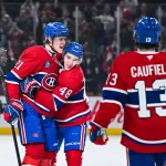 Apr 16, 2025; Montreal, Quebec, CAN; Montreal Canadiens defenseman Kaiden Guhle (21) celebrates with defenseman Lane Hutson (48) his goal against the Carolina Hurricanes in the first period at Bell Centre.