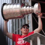 Jun 20, 2026; Raleigh, North Carolina, USA; Carolina Hurricanes defenseman Alexander Nikishin (21) holds up the Stanley Cup Trophy during the Stanley Cup championship parade and rally at Raleigh.