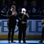 Dec 16, 2025; Toronto, Ontario, CAN; Toronto Maple Leafs broadcaster Joe Bowen is over come with emotion after being presented with a golden microphone by former Toronto Maple Leafs player Wendel Clark before a game against the Chicago Blackhawks at Scotiabank Arena.