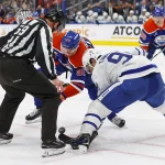 Feb 1, 2025; Edmonton, Alberta, CAN; Edmonton Oilers forward Connor McDavid (97) and Toronto Maple Leafs forward Auston Matthews (34) face-off during the third period at Rogers Place.