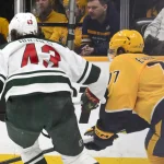 Feb 4, 2026; Nashville, Tennessee, USA; Minnesota Wild goaltender Filip Gustavsson (32) blocks the shot of Nashville Predators right wing Luke Evangelista (77) during the first period at Bridgestone Arena.