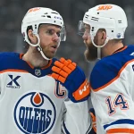 Feb 26, 2026; Los Angeles, California, USA; Edmonton Oilers center Connor McDavid (97) talks to Edmonton Oilers center Adam Henrique (19) during the first period between the Edmonton Oilers and the Los Angeles Kings at Crypto.com Arena.