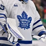 Dec 21, 2025; Dallas, Texas, USA; A view of the logo on the jersey of Toronto Maple Leafs goaltender Dennis Hildeby (35) during the game at the American Airlines Center.
