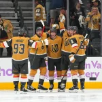Nov 18, 2025; Las Vegas, Nevada, USA; Vegas Golden Knights defenseman Ben Hutton (17) celebrates with team mates after scoring a goal against the New York Rangers during the second period at T-Mobile Arena.