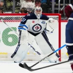 Mar 28, 2026; Denver, Colorado, USA; Winnipeg Jets goaltender Connor Hellebuyck (37) defends the net in the first period against the Colorado Avalanche at Ball Arena.