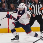 Jan 6, 2026; San Jose, California, USA; Columbus Blue Jackets center Adam Fantilli (19) shoots the puck against the San Jose Sharks in the first period at SAP Center at San Jose.