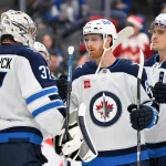 Dec 23, 2024; Toronto, Ontario, CAN; Winnipeg Jets goalie Connor Hellebuyck (37) is joined by forwards Kyle Connor (81) and Mark Scheifele (55) as they celebrate a win over the Toronto Maple Leaf at Scotiabank Arena.