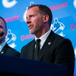 May 14, 2026; Vancouver, BC, Canada; Daniel Sedin listens to Ryan Johnson speak during a press conference where the Vancouver Canucks name new senior management staff. Henrik Sedin and his twin brother Daniel Sedin have been appointed as co-presidents of hockey operations and Ryan Johnson is now the new general manager of the club at Rogers Arena.: