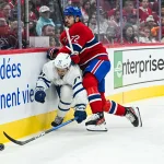 Sep 19, 2026; Montreal, Quebec, CAN; Montreal Canadiens Arber Xhekaj defenseman (72) checks Toronto Maple Leafs Ryan Tverberg center (77) into the boards during the first period at Bell Centre.