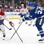 Sep 19, 2026; Toronto, Ontario, CAN; Toronto Maple Leafs forward Auston Matthews (34) shoots the puck as Montreal Canadiens defenseman Noah Dobson (53) defends in the first period at Scotiabank Arena.