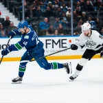Apr 14, 2026; Vancouver, British Columbia, CAN; Los Angeles Kings forward Adrian Kempe (9) stick checks Vancouver Canucks forward Elias Pettersson (40) while shooting in the third period at Rogers Arena.