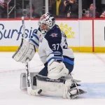Jan 27, 2026; Newark, New Jersey, USA; Winnipeg Jets goaltender Connor Hellebuyck (37) makes a save against the New Jersey Devils during the second period at Prudential Center.