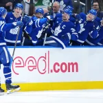 Dec 16, 2025; Toronto, Ontario, CAN; Toronto Maple Leafs center Dakota Joshua (81) celebrates at the bench after scoring a goal against the Chicago Blackhawks during the third period at Scotiabank Arena.