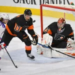 Dec 23, 2019; Philadelphia, Pennsylvania, USA; New York Rangers left wing Artemi Panarin (10) and Philadelphia Flyers center Kevin Hayes (13) flow the puck with goaltender Carter Hart (79) during the third period at Wells Fargo Center.