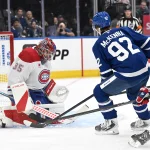 Sep 19, 2026; Toronto, Ontario, CAN; Montreal Canadiens goalie Sam Montembeault (35) makes a save on a shot from Toronto Maple Leafs forward Gavin McKenna (92) in the first period at Scotiabank Arena.