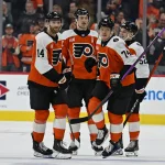 Dec 22, 2025; Philadelphia, Pennsylvania, USA; Philadelphia Flyers right wing Owen Tippett (74) celebrates his goal with center Sean Couturier (14), defenseman Travis Sanheim (6) and center Denver Barkey (52) against the Vancouver Canucks at Xfinity Mobile Arena.