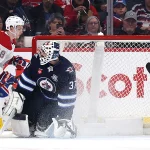 Feb 4, 2026; Winnipeg, Manitoba, CAN; Montreal Canadiens defenseman Lane Hutson (48) scores against Winnipeg Jets goaltender Connor Hellebuyck (37) in the second period at Canada Life Centre.