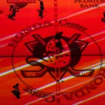 Apr 13, 2025; Anaheim, California, USA; Colorado Avalanche and Anaheim Ducks players skate across the Ducks logo at center ice in the second period at Honda Center.
