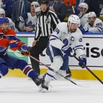 Feb 3, 2026; Edmonton, Alberta, CAN; Edmonton Oilers forward Connor McDavid (97) tries to knock the puck away from Toronto Maple Leafs forward Auston Matthews (34) during the first period at Rogers Place.