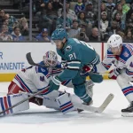 Jan 23, 2026; San Jose, California, USA; San Jose Sharks center Alexander Wennberg (21) attempts to shoot past New York Rangers goaltender Spencer Martin (41) during the second period at SAP Center at San Jose.