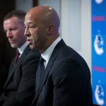 Jun 4, 2026; Vancouver, BC, CANADA; General manager Ryan Johnson listens to Manny Malhotra speak during press conference where the Vancouver Canucks introduce Malhotra as their new head coach during a press conference at Rogers Arena. :