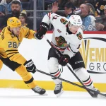 Jan 29, 2026; Pittsburgh, Pennsylvania, USA; Chicago Blackhawks center Oliver Moore (11) moves the puck against Pittsburgh Penguins defenseman Parker Wotherspoon (28) during the first period at PPG Paints Arena.