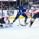 Apr 8, 2026; Toronto, Ontario, CAN; Toronto Maple Leafs center Steven Lorentz (18) battles for the puck in front of Washington Capitals goaltender Logan Thompson (48) during the first period at Scotiabank Arena.