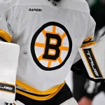 Jan 20, 2026; Dallas, Texas, USA; A view of the Boston Bruins logo on the jersey of Boston Bruins goaltender Jeremy Swayman (1) during the game at the American Airlines Center.
