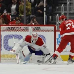 Nov 8, 2022; Detroit, Michigan, USA; Montreal Canadiens goaltender Jake Allen (34) makes a save on Detroit Red Wings center Dylan Larkin (71) in the first period at Little Caesars Arena.