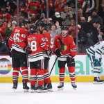 Feb 2, 2026; Chicago, Illinois, USA; Chicago Blackhawks defenseman Louis Crevier (46), defenseman Matt Grzelcyk (48), right wing Ilya Mikheyev (95) and center Ryan Donato (8) celebrate a third-period goal against the San Jose Sharks at United Center.