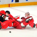 Sep 20, 2026; Sunrise, Florida, USA; Carolina Hurricanes goalie Pyotr Kochetkov (52) makes a save against Florida Panthers forward Sandis Vilmanis (95) during the third period at Amerant Bank Arena.