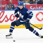 Sep 23, 2026; Toronto, Ontario, CAN; Toronto Maple Leafs forward Gavin McKenna (92) stretches to control a pass against the Ottawa Senators in the third period at Scotiabank Arena.