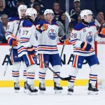 Sep 23, 2025; Winnipeg, Manitoba, CAN; Edmonton Oilers forward Quinn Hutson (28) is congratulated by his teammates after scoring against the Winnipeg Jets during the second period at Canada Life Centre.
