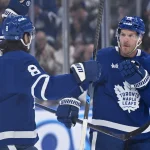 Oct 14, 2025; Toronto, Ontario, CAN; Toronto Maple Leafs defenseman Jake McCabe (22) celebrates with defenseman Chris Tanev (8) after scoring a goal against the Nashville Predators in the first period at Scotiabank Arena.