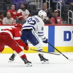 Oct 3, 2024; Detroit, Michigan, USA; Toronto Maple Leafs left wing Alex Nylander (92) skates with the puck defended by Detroit Red Wings right wing Alex DeBrincat (93) in the third period at Little Caesars Arena.