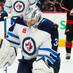 Mar 9, 2025; Raleigh, North Carolina, USA; Winnipeg Jets goaltender Connor Hellebuyck (37) makes a save against the Carolina Hurricanes during the first period at Lenovo Center.