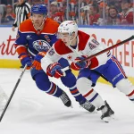 Mar 6, 2025; Edmonton, Alberta, CAN; Montreal Canadiens defensemen Lane Hutton (48) and Edmonton Oilers forward Connor McDavid (97) look for a loose puck during the first period at Rogers Place.