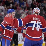 Nov 22, 2025; Montreal, Quebec, CAN; Montreal Canadiens forward Florian Xhekaj (63) and teammate goalie Jakub Dobes (75) celebrate the win against the Toronto Maple Leafs at the Bell Centre. :