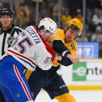 Apr 6, 2025; Nashville, Tennessee, USA; Nashville Predators defenseman Andreas Englund (8) and Montreal Canadiens left wing Michael Pezzetta (55) exchange blows during the first period at Bridgestone Arena.