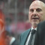 Oct 11, 2025; Raleigh, North Carolina, USA; Philadelphia Flyers head coach Rick Tocchet looks on from behind the players bench against the Carolina Hurricanes during the first period at Lenovo Center.